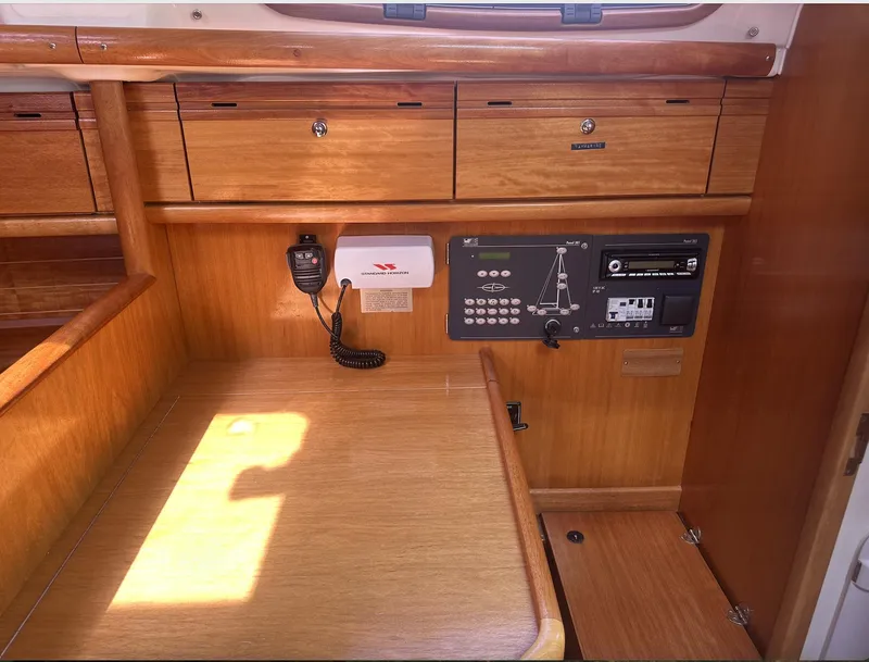 Slide: The Image of 2007 Bavaria 30 Cruiser interior with wooden cabinetry and navigation controls. - 16