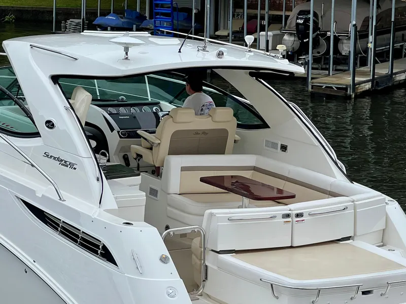 Slide: The Image of 2014 Sea Ray 410 Sundancer yacht with elegant seating and modern dashboard. - 11