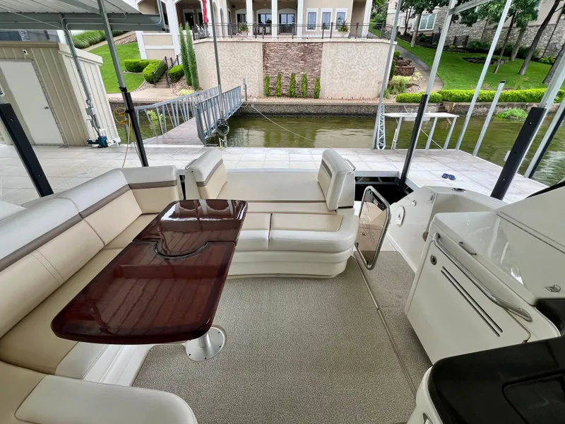 Slide: The Image of Luxurious 2014 Sea Ray 410 Sundancer yacht interior with elegant seating and polished table. - 15