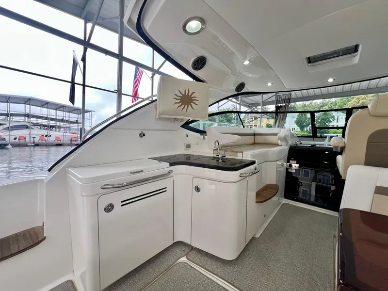 Slide: The Image of Interior of 2014 Sea Ray 410 Sundancer yacht with modern kitchen and seating area. - 16