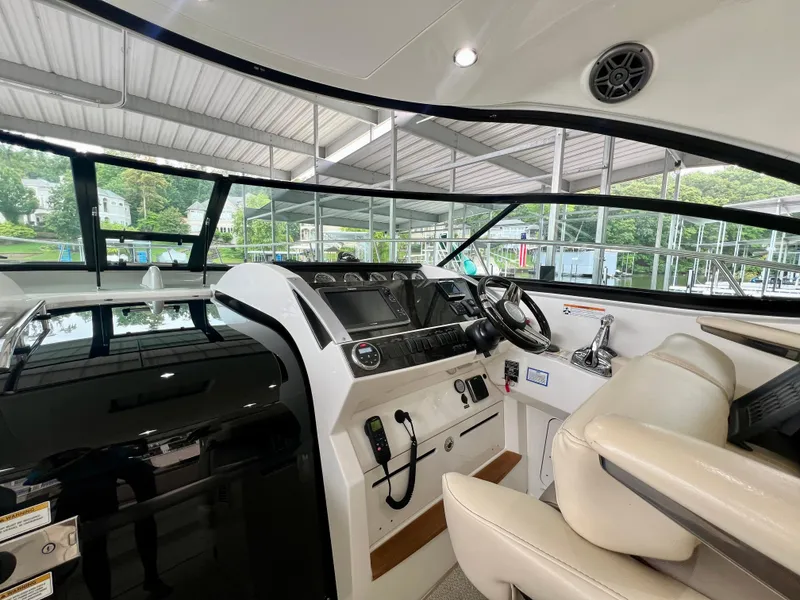 Slide: The Image of Interior helm of 2014 Sea Ray 410 Sundancer yacht with modern controls and seating. - 22
