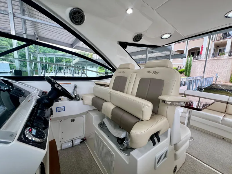 Slide: The Image of Interior of 2014 Sea Ray 410 Sundancer yacht with luxurious seating and modern helm controls. - 23