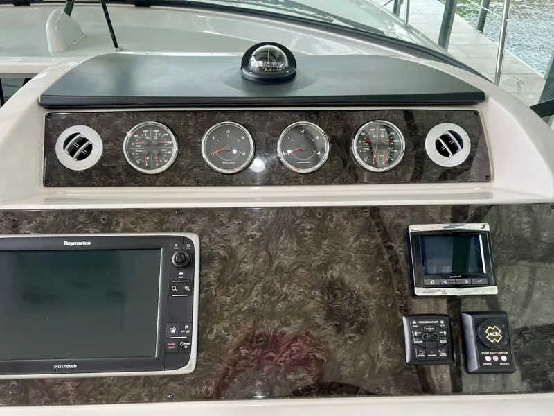 Slide: The Image of Control panel of a 2014 Sea Ray 410 Sundancer with gauges and navigation equipment. - 31