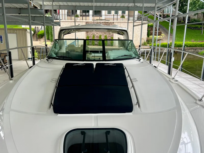 Slide: The Image of 2014 Sea Ray 410 Sundancer yacht docked, featuring sleek design and spacious deck. - 35