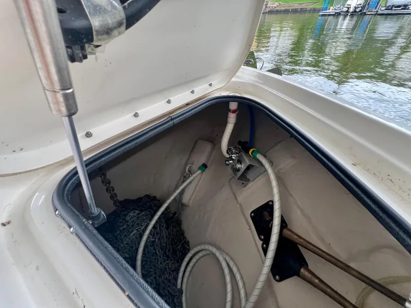 Slide: The Image of Anchor locker of 2014 Sea Ray 410 Sundancer with chain and hoses visible. - 36