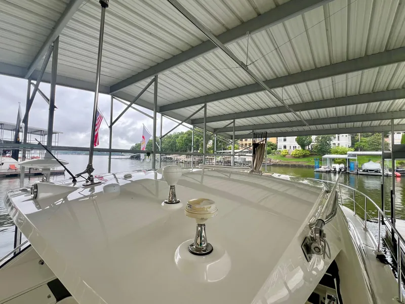 Slide: The Image of 2014 Sea Ray 410 Sundancer yacht docked under a covered marina. - 37