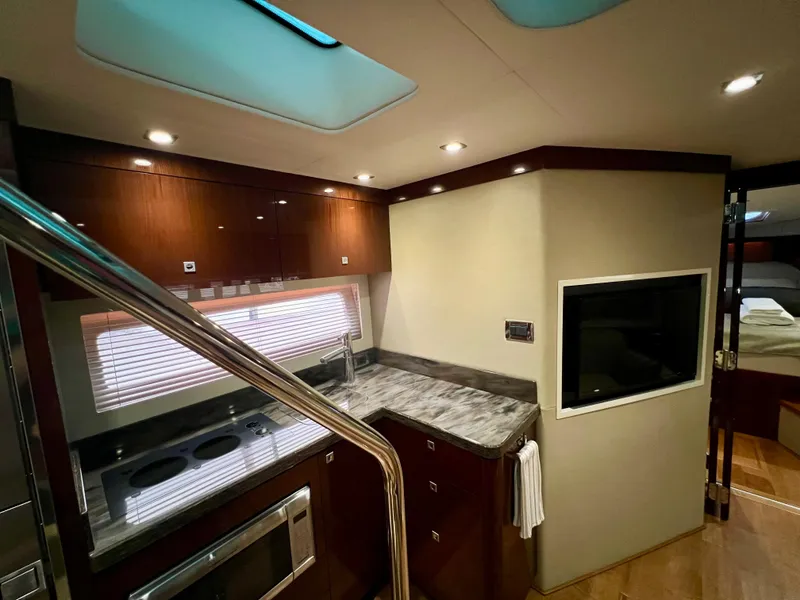 Slide: The Image of Luxurious interior of 2014 Sea Ray 410 Sundancer yacht with modern kitchen and sleek design. - 40
