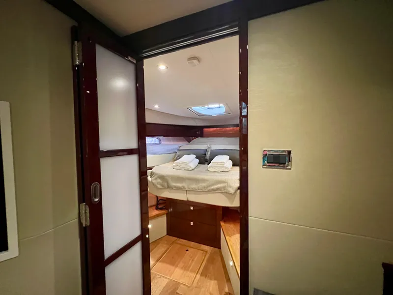 Slide: The Image of Luxurious cabin interior of 2014 Sea Ray 410 Sundancer yacht with bed and skylight. - 48