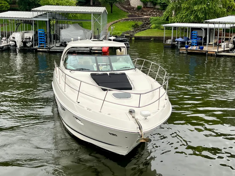 Slide: The Image of 2014 Sea Ray 410 Sundancer yacht docked on a serene lake. - 5