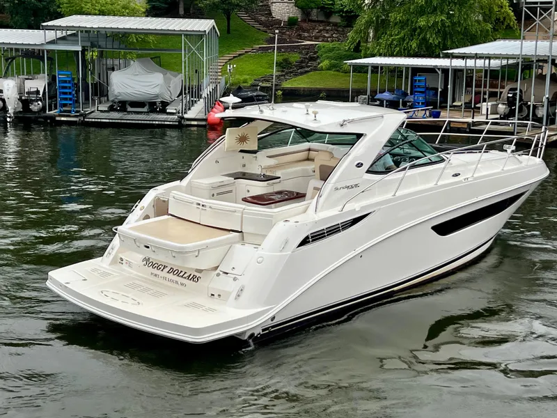 Slide: The Image of 2014 Sea Ray 410 Sundancer yacht docked on calm water. - 8