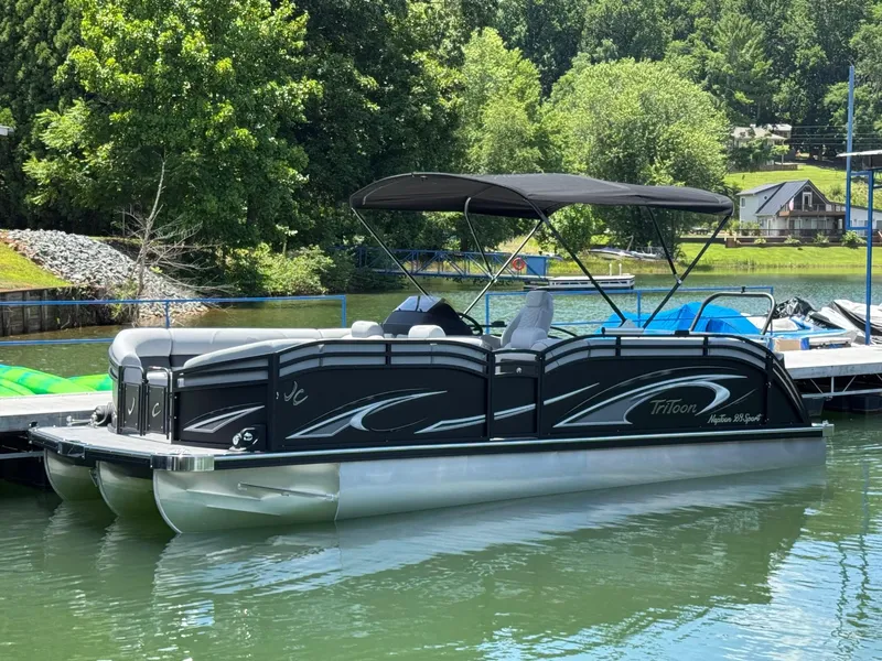The Image of 2026 JC Neptoon Sport 23TT pontoon boat docked on a serene lake. - 1