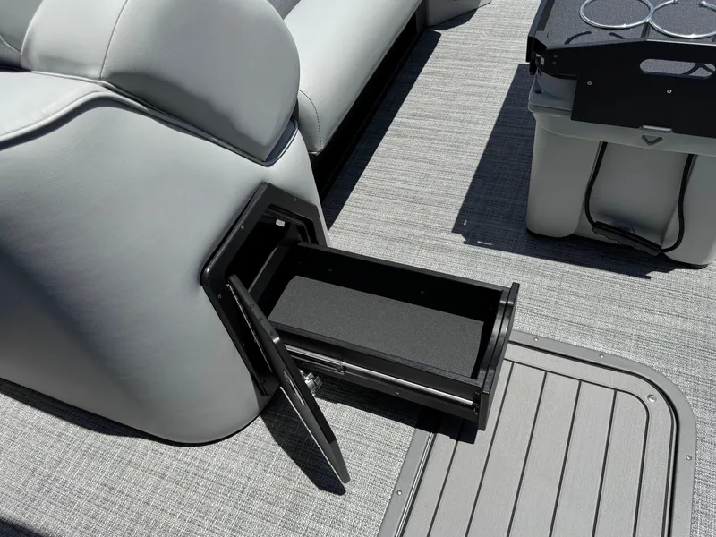 Slide: The Image of Open storage drawer on 2026 JC Neptoon Sport 23TT boat with gray seating and flooring. - 10