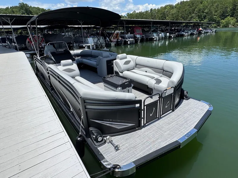 Slide: The Image of 2026 JC Neptoon Sport 23TT pontoon boat docked on a serene lake. - 3