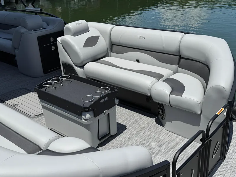 Slide: The Image of 2026 JC Neptoon Sport 23TT pontoon boat with luxurious seating and cup holders on a sunny day. - 4