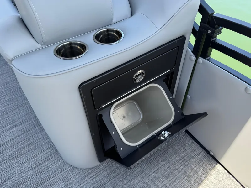 Slide: The Image of 2026 JC Neptoon Sport 23TT boat interior with cup holders and storage compartment. - 12