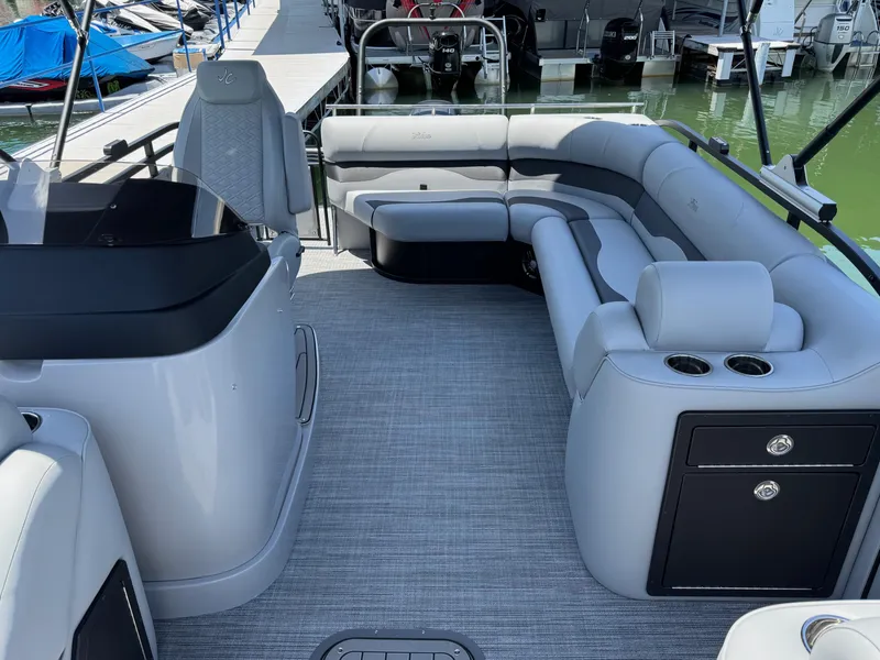 Slide: The Image of 2026 JC Neptoon Sport 23TT pontoon boat interior with gray seating and modern design. - 13