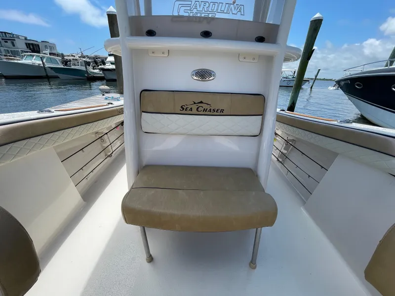 Slide: The Image of 2023 Sea Chaser 24 HFC boat interior with seating, docked at marina. - 17