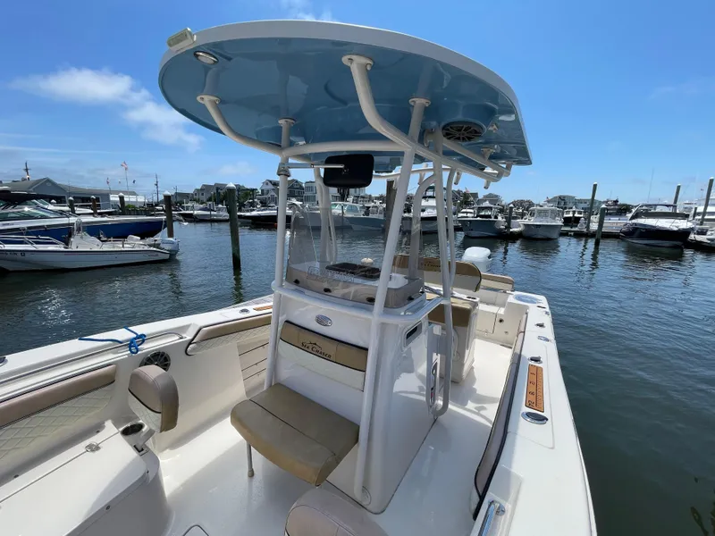 Slide: The Image of 2023 Sea Chaser 24 HFC boat docked at marina under clear blue sky. - 18