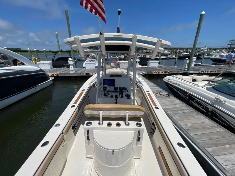Slide: The Image of 2023 Sea Chaser 24 HFC boat docked at marina under clear blue sky. - 24