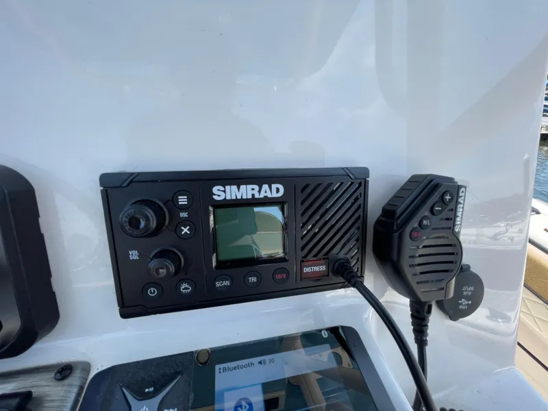 Slide: The Image of Simrad marine radio system on 2023 Sea Chaser 24 HFC boat dashboard. - 30