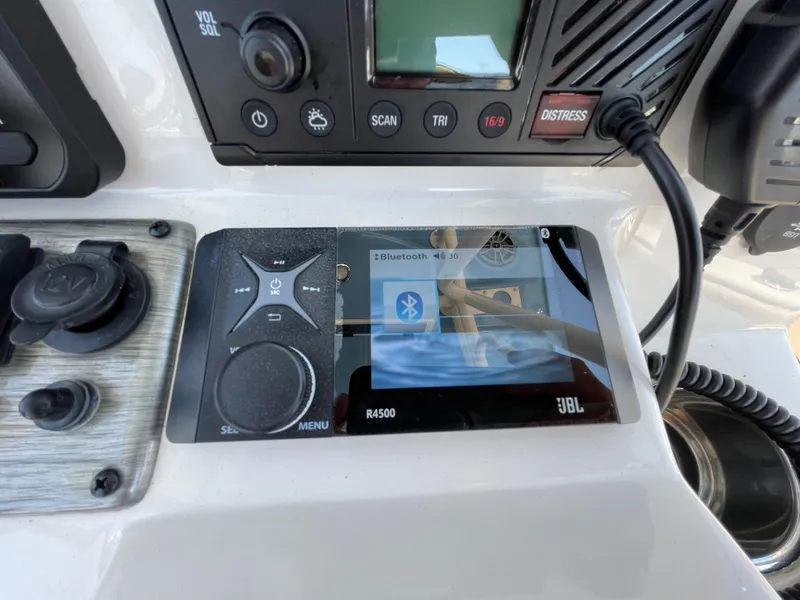 Slide: The Image of Control panel of 2023 Sea Chaser 24 HFC with JBL Bluetooth display. - 31