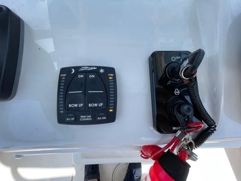 Slide: The Image of Control panel of a 2023 Sea Chaser 24 HFC boat with trim tab controls. - 34