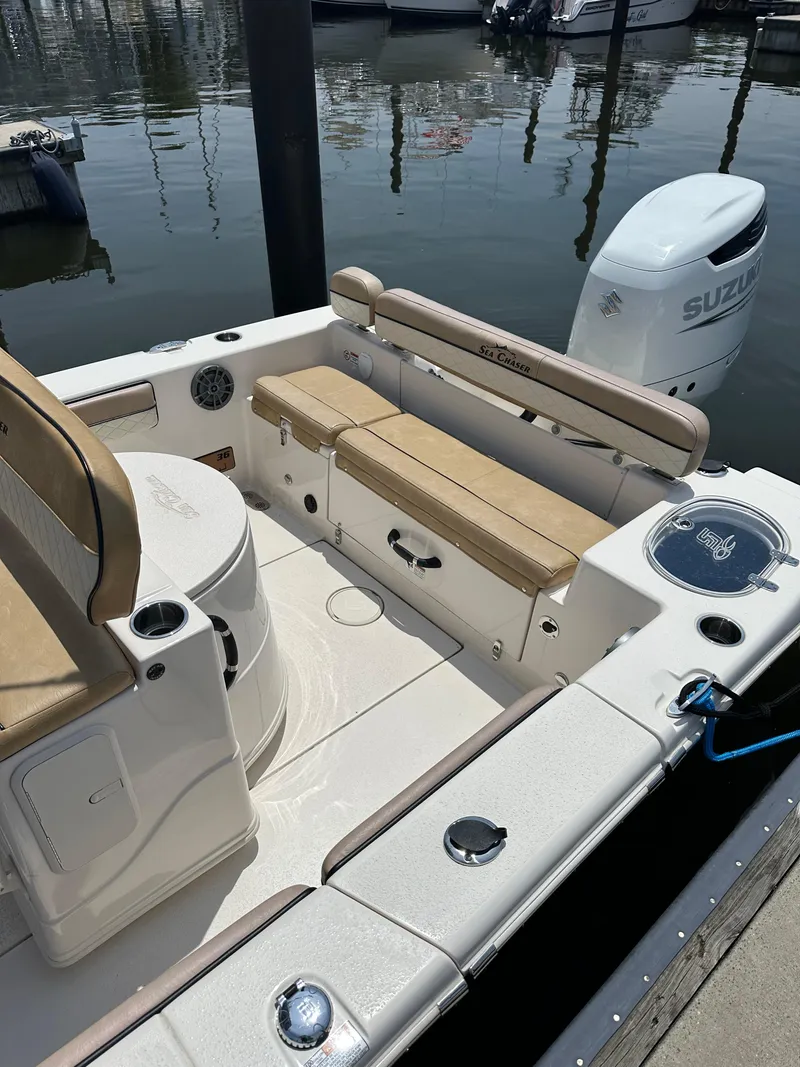Slide: The Image of 2023 Sea Chaser 24 HFC boat interior with seating and Suzuki outboard motor. - 37