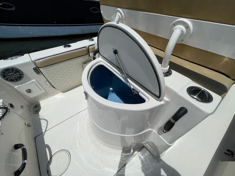 Slide: The Image of 2023 Sea Chaser 24 HFC boat interior with open storage compartment and seating. - 39