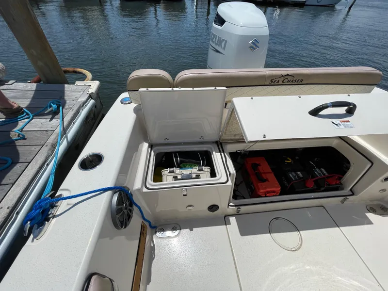 Slide: The Image of 2023 Sea Chaser 24 HFC boat with open storage compartments at dockside. - 41