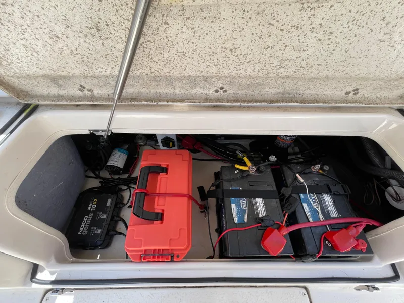 Slide: The Image of 2023 Sea Chaser 24 HFC boat battery compartment with dual batteries and charger. - 42