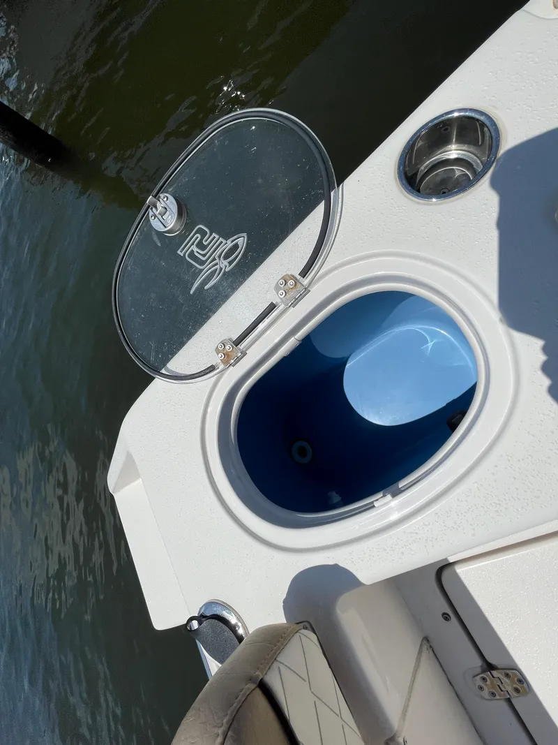 Slide: The Image of 2023 Sea Chaser 24 HFC boat with open storage compartment by the water. - 44