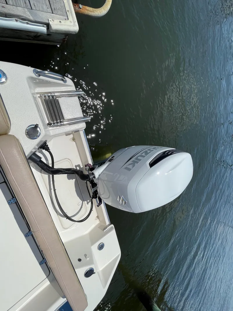 Slide: The Image of 2023 Sea Chaser 24 HFC boat with Suzuki outboard motor at dock. - 47