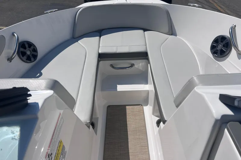 Slide: The Image of 2020 Sea Ray SPX 210 boat interior with cushioned seating and speakers. - 14