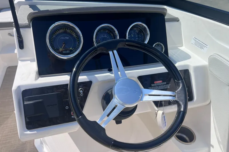 Slide: The Image of Steering wheel and dashboard of 2020 Sea Ray SPX 210 boat, featuring gauges and controls. - 15