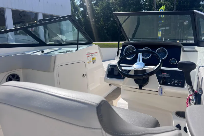 Slide: The Image of Interior view of 2020 Sea Ray SPX 210 boat cockpit with steering wheel and dashboard. - 16
