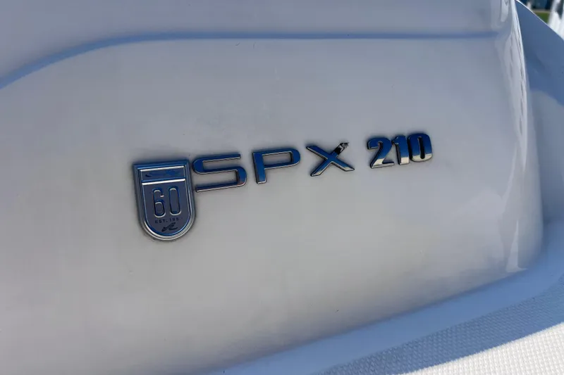 Slide: The Image of 2020 Sea Ray SPX 210 emblem on white surface, showcasing model branding. - 18