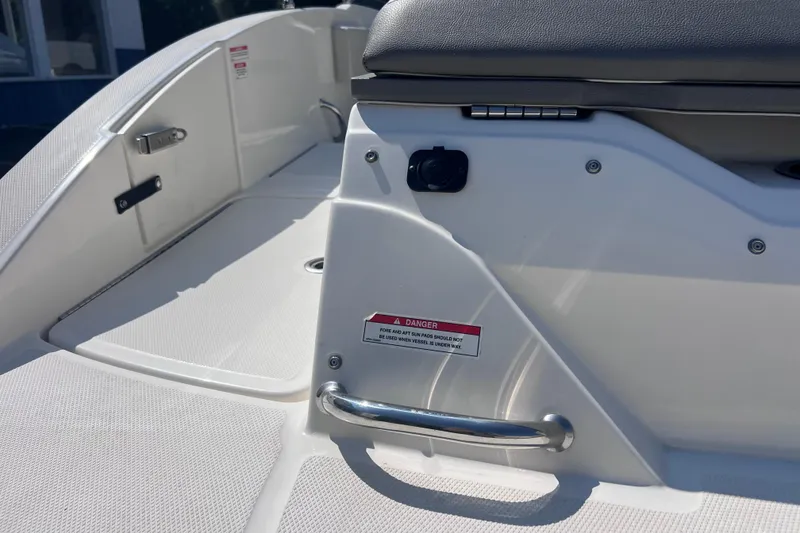 Slide: The Image of 2020 Sea Ray SPX 210 boat interior detail with safety warning label and seating. - 19