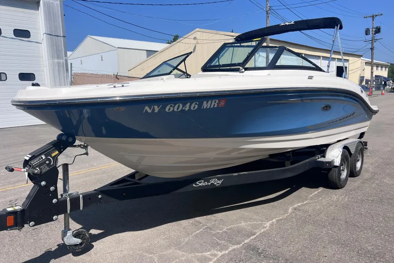 Slide: The Image of 2020 Sea Ray SPX 210 boat on trailer, parked outdoors. - 2