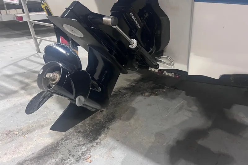 Slide: The Image of 2020 Sea Ray SPX 210 boat with MerCruiser outboard motor in a garage setting. - 6