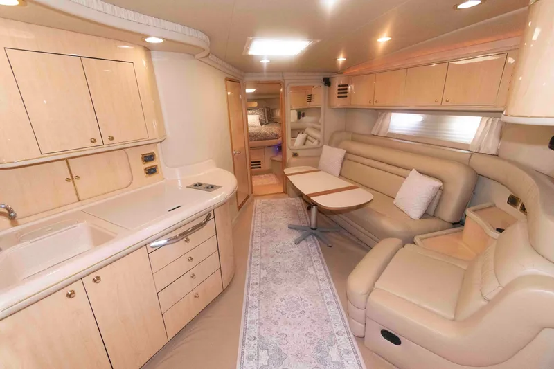 Slide: The Image of Luxurious interior of 2001 Sea Ray 460 Sundancer yacht with beige furnishings and kitchenette. - 10