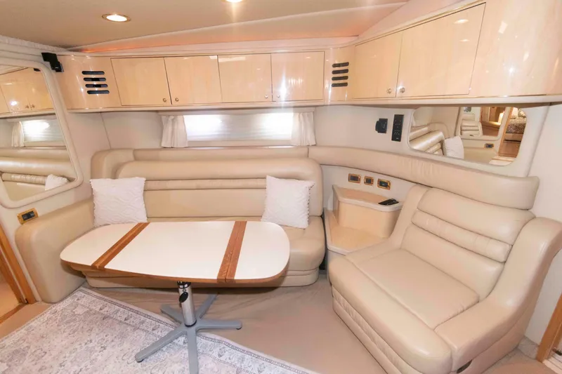 Slide: The Image of Interior of 2001 Sea Ray 460 Sundancer yacht with beige leather seating and wooden table. - 11