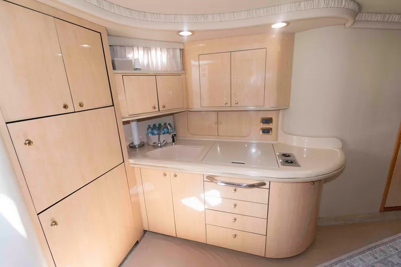 Slide: The Image of 2001 Sea Ray 460 Sundancer yacht kitchen with light wood cabinetry and modern appliances. - 12