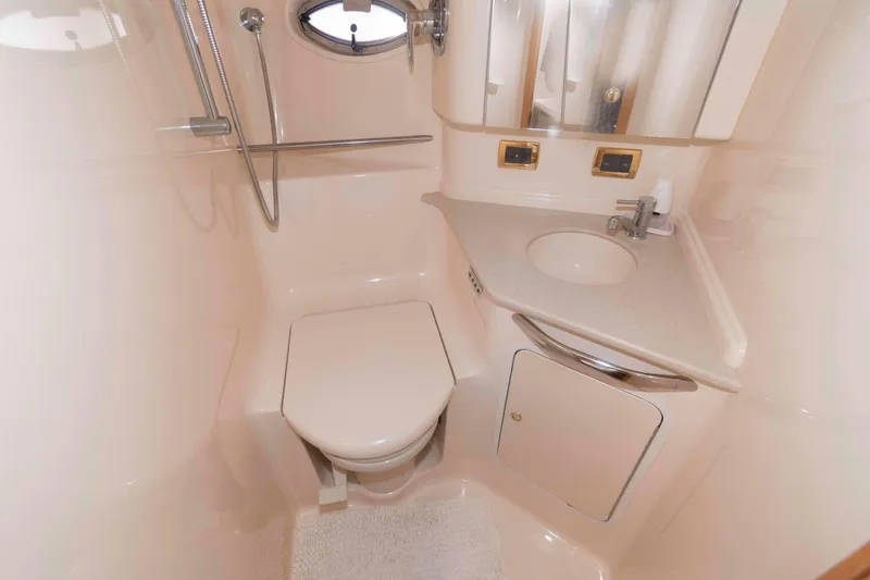 Slide: The Image of Luxurious bathroom in 2001 Sea Ray 460 Sundancer yacht, featuring toilet and sink. - 17