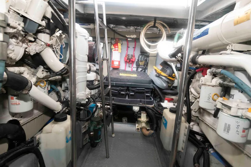 Slide: The Image of Engine room of 2001 Sea Ray 460 Sundancer yacht, showcasing mechanical components and equipment. - 18