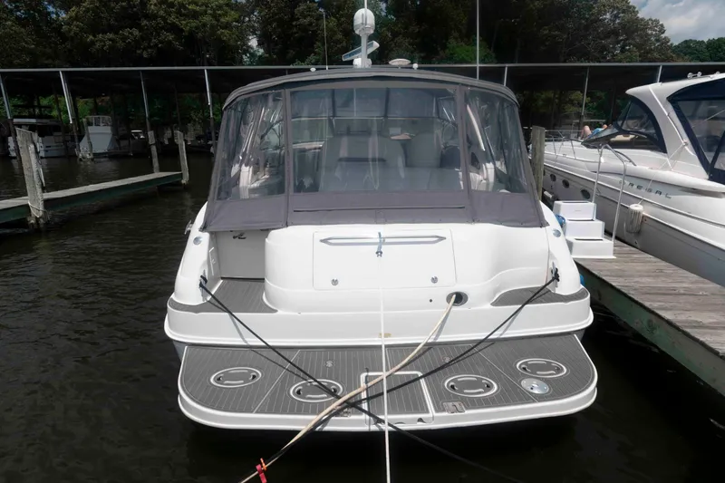 Slide: The Image of 2001 Sea Ray 460 Sundancer yacht docked at marina, rear view. - 2