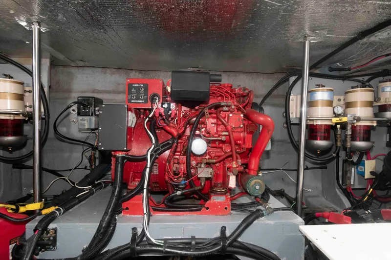 Slide: The Image of Engine room of 2001 Sea Ray 460 Sundancer with red machinery and wiring. - 24