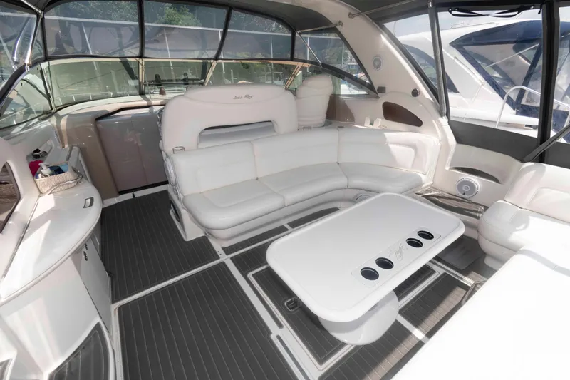 Slide: The Image of Luxurious interior of 2001 Sea Ray 460 Sundancer yacht with white seating and table. - 4