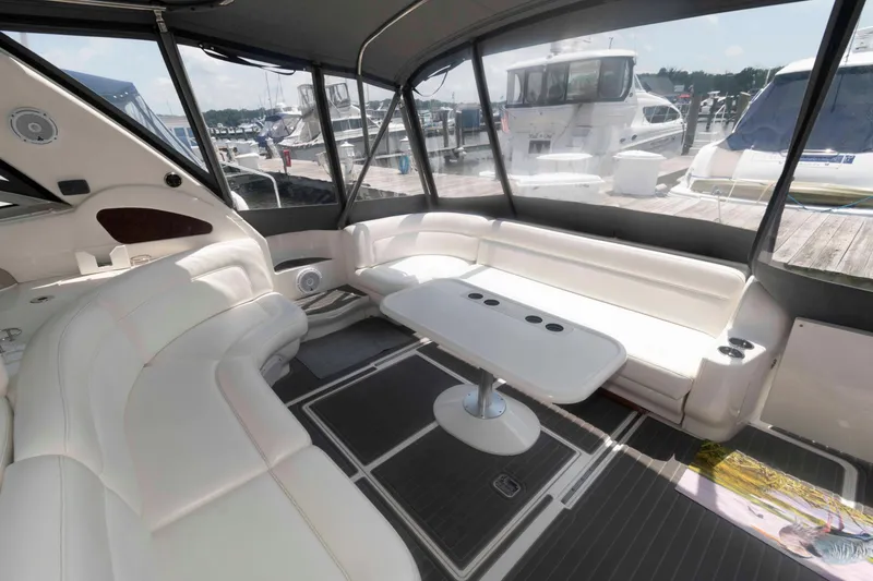 Slide: The Image of Luxurious interior of a 2001 Sea Ray 460 Sundancer yacht with white seating and table. - 5