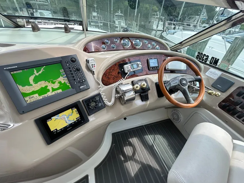 Slide: The Image of Helm of 2001 Sea Ray 460 Sundancer with navigation screens and wooden steering wheel. - 8