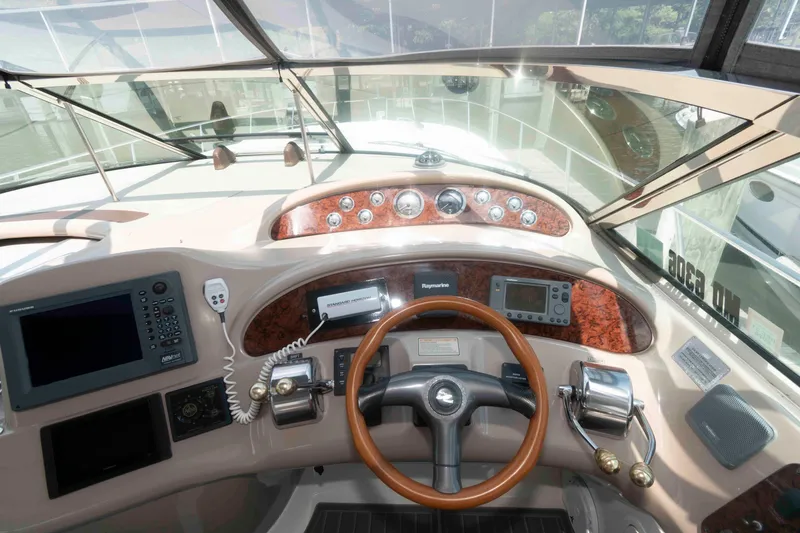 Slide: The Image of Cockpit of 2001 Sea Ray 460 Sundancer with steering wheel and navigation instruments. - 9